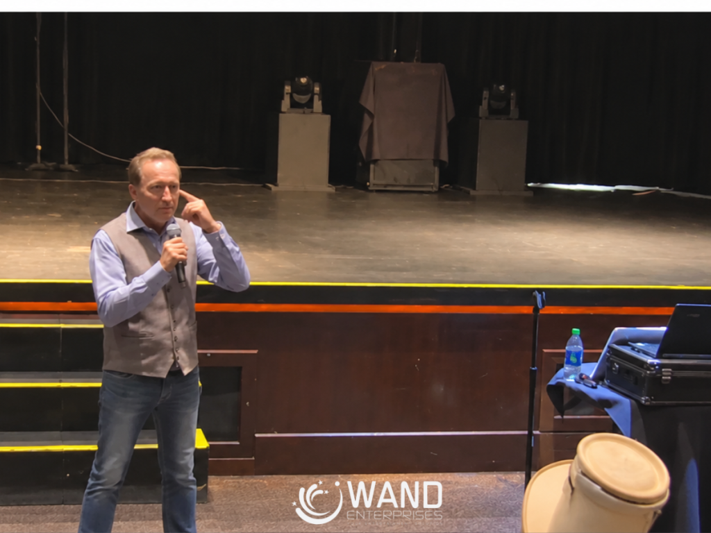 Jim Wand demonstrating stage hypnosis course techniques on stage
